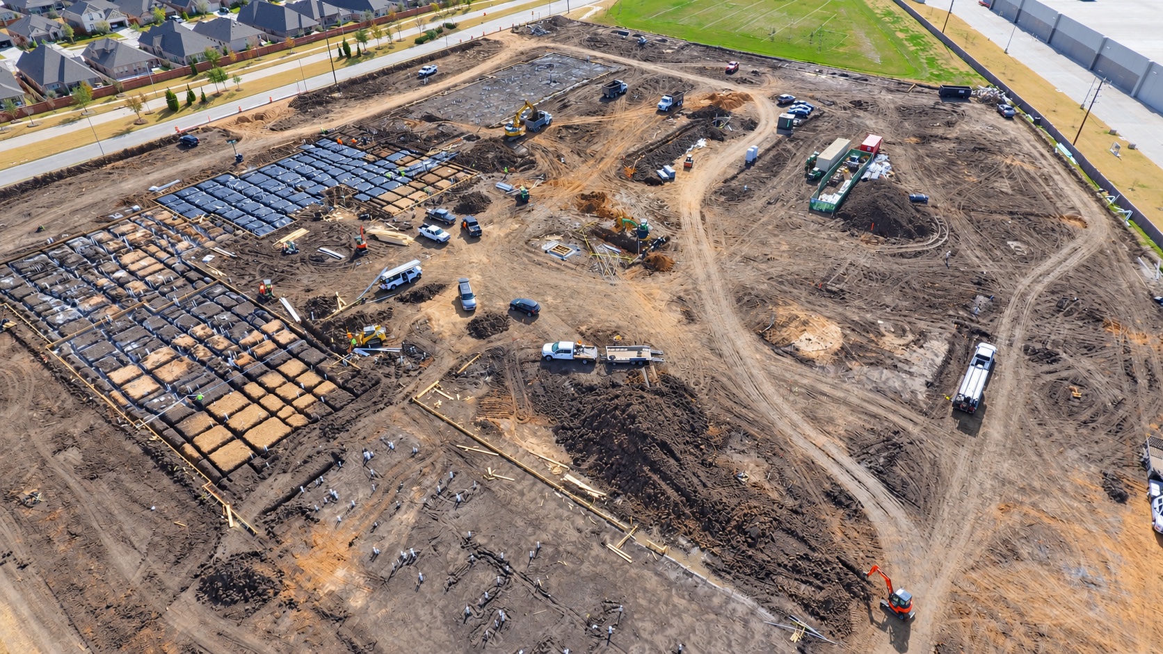 Earthwork and foundation preparation across an active jobsite