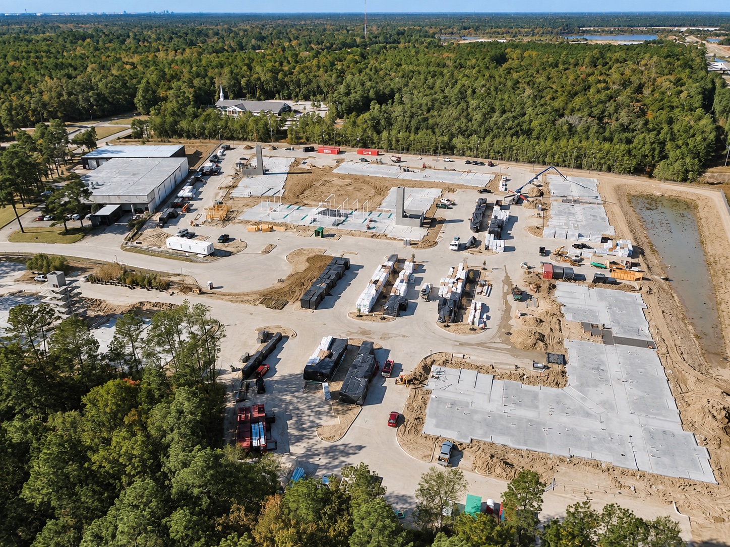 A broad view of construction progress with concrete foundations and equipment