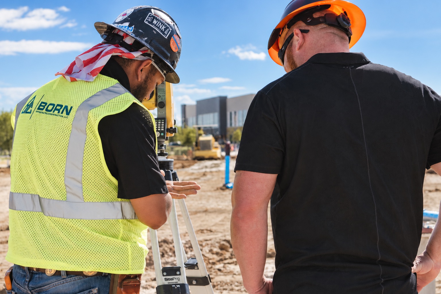 BORN crew members working together with surveying equipment